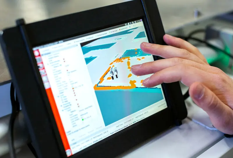 Hand using a touch-screen industrial panel PC